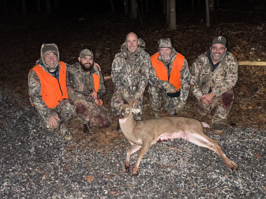 Redbillies-Outdoors-hunters holding a seven point buck